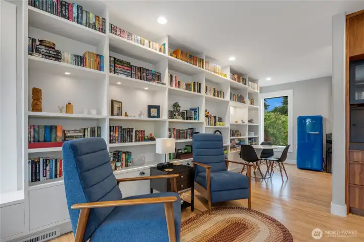 Ample shelving accents the full expanse of the west wall and leads you to the open butler's pantry.