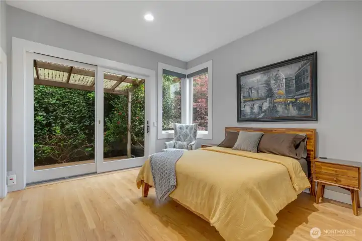 Toward the back of the bedroom floor, this well-sized room opens to a small covered deck and patio. The closet is currently utilzed for laundry with its washer and dryer hook-ups. There are additional laundry connections in the lower room.