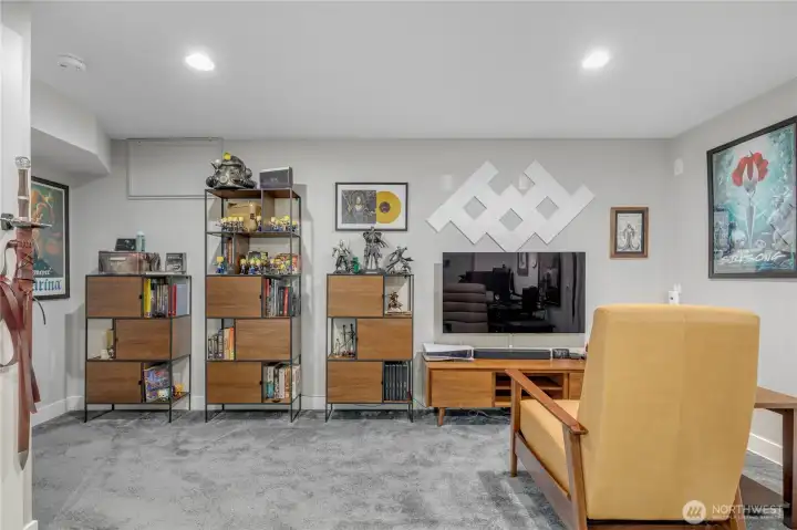 On the lower level, this room has converted to office space. It has hookups for a washer and dryier on the west wall. The additional laundry option is in use in the back bedroom one floor up for convenience. The closet in this room houses the on-demand water heater, and the air handler for the whole-house HVAC system.