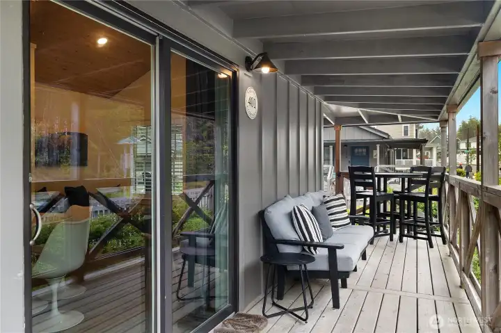 Step out of the sliding glass door onto the covered, wraparound porch - perfect for enjoying the ocean breezes