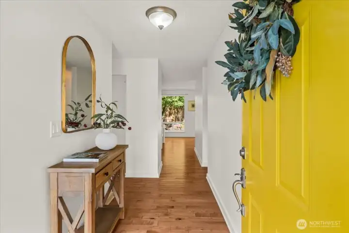 Foyer – Bright entry hall with hardwood flooring, neutral wall colors, and a clean, open layout. Sightlines extend toward the main living spaces and backyard views.
