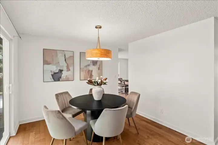 Family Room – Dedicated dining space with hardwood flooring and contemporary light fixture. Positioned adjacent to outdoor access for easy indoor-outdoor entertaining.