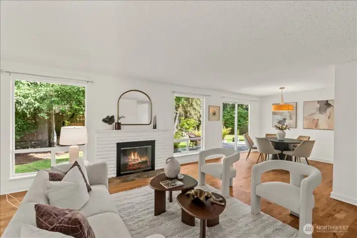 Family Room & Dining Area – Open-concept living and dining spaces featuring hardwood floors, large windows, a wood fireplace, and backyard views. Sliding glass doors provide direct access to the outdoor living area.