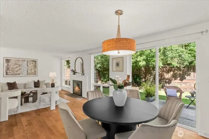 Dining Area – Open dining space positioned alongside the living room and outdoor access. Large windows and sliding glass doors create a seamless connection to the backyard.