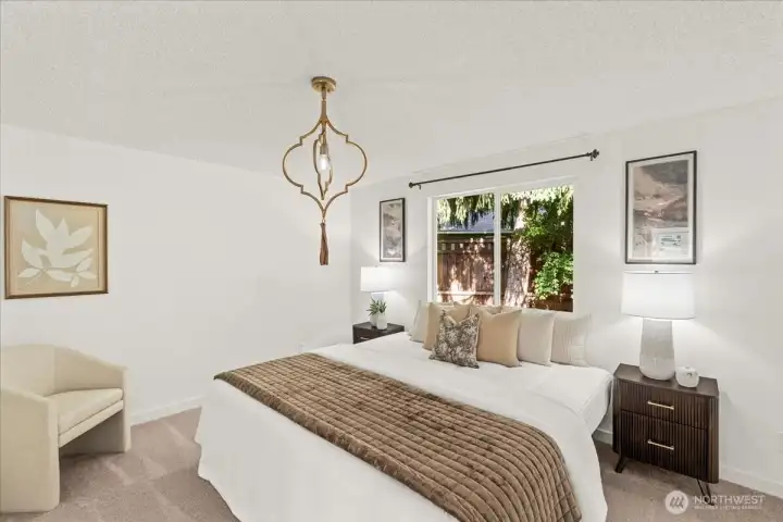 Primary Bedroom – Comfortable bedroom with soft carpeting, large window, and neutral finishes. Generous natural light creates a bright and inviting retreat.