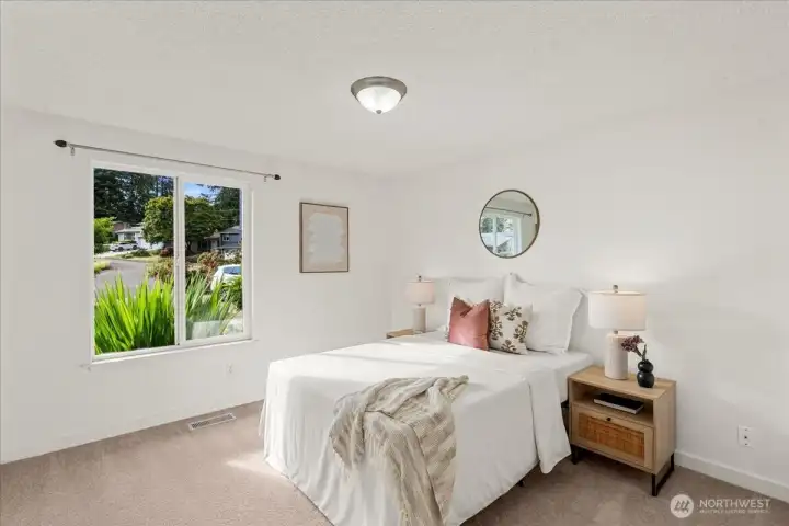 Bedroom – Bright secondary bedroom with plush carpeting, large window, and neutral color palette. Comfortable layout offers abundant natural light.