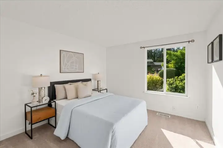 Bedroom – Secondary bedroom with expansive window, soft carpeting, and clean finishes. Natural light highlights the spacious feel of the room.