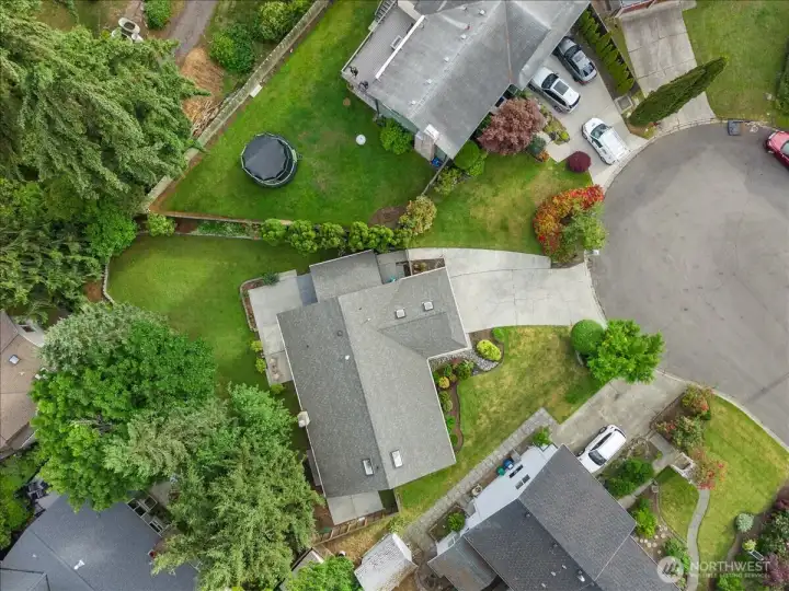 Aerial Property View – Overhead view highlighting the home's footprint, driveway, yard space, and surrounding landscaping. Provides a clear perspective of the property layout.