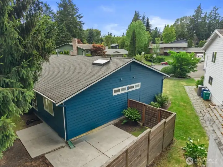Side Exterior – Side view of the home featuring exterior siding, fenced patio area, and landscaped surroundings. Highlights additional outdoor space and property access.