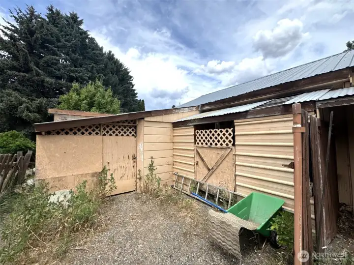 Far left side of the garage, beyond the carport.  More storage!