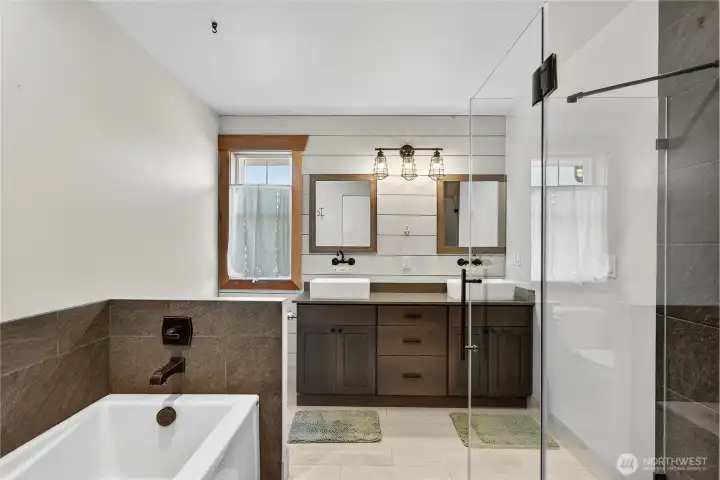 Modern Primary ensuite with soaking tub and glass paneled shower.