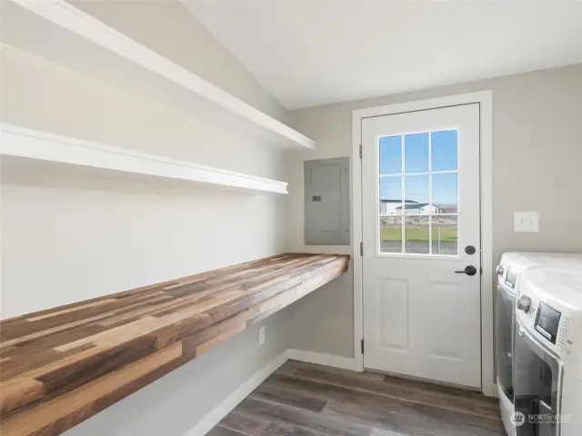 Laundry room with extra storage and washer and dryer included.