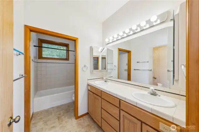 Guest bath with dual sinks and privacy door.