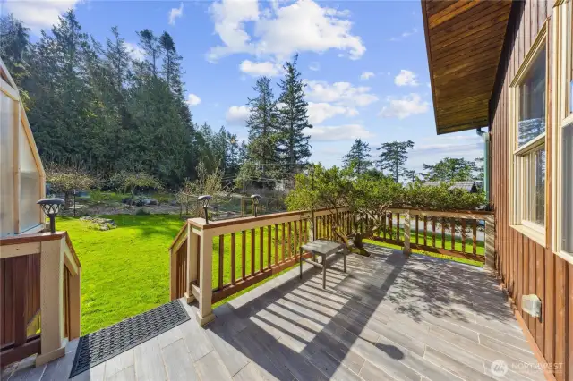 Private deck leads to garden & greenhouse on left.