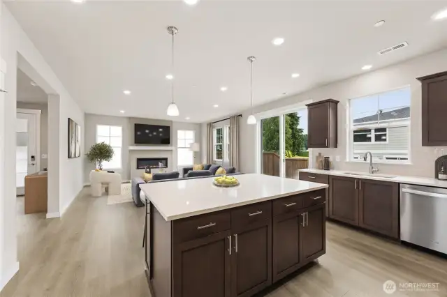 Large open concept great room and kitchen with large island with breakfast bar.