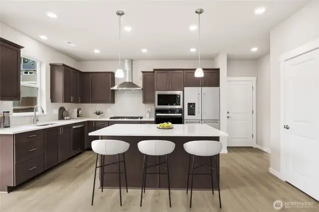 Gas cooktop, quartz countertops, gourmet hood vent, dishwasher, pendent lighting, soft close cabinets, built-in oven and microwave all included.