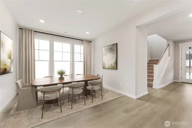 Open concept formal dining room. Virtual staging in photo.