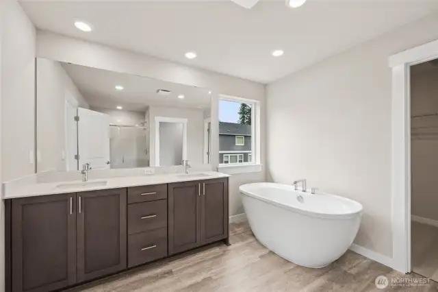 5-piece primary bathroom includes step-in shower, double vanity, and freestanding bathtub.