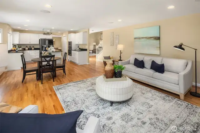 Heading out the main entry, if you go around the stairs you'll reach the powder room, the laundry and entry to the garage, as well as the office which has a closet, making it a 5th bedroom.