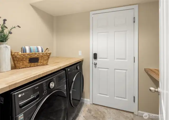 Newer LG ThinQ washer and dryer, as well as custom folding table make light work of laundry!  Door leads to garage.