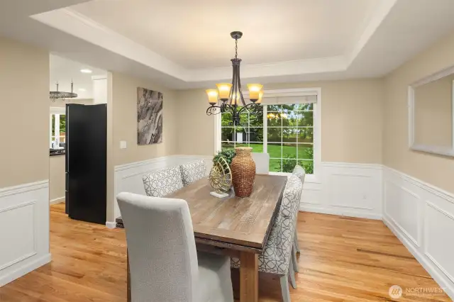 Tray ceiling and wainscotting in dining  room add a layer of elegance.