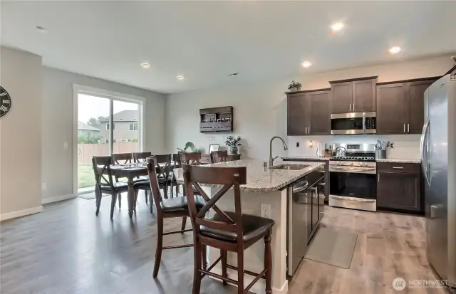 Spacious kitchen/eating area. Stainless appliances, gas range and a large island with additional eating space. Granite counters are lovely.