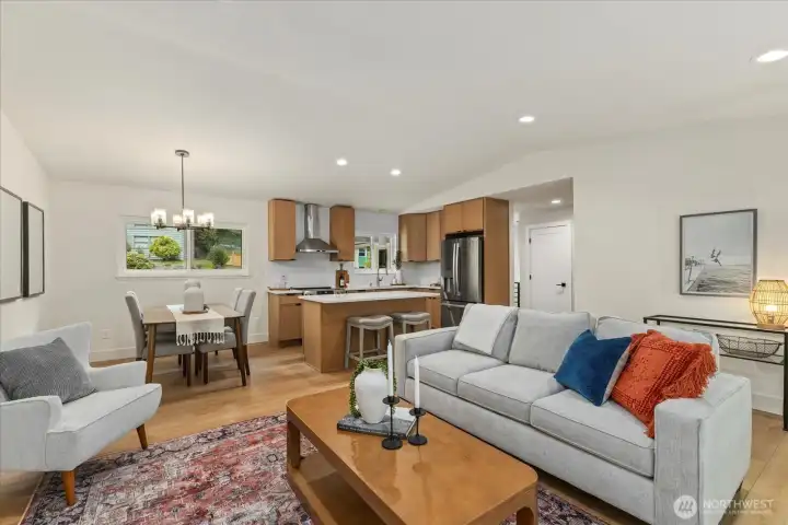 Living room, kitchen, and dining areas - all completely remodeled with new can lighting and fireplace.