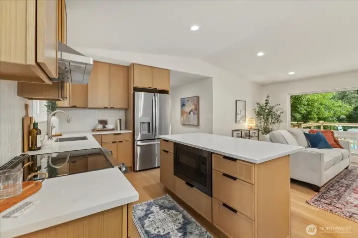 Beautifully remodeled kitchen with 3cm quartz countertops, kitchen island, custom dishwasher front and more.
