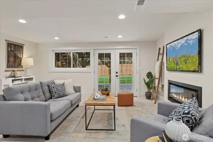 Downstairs family room with electric fireplace and bar area.  Opens out to the back yard.