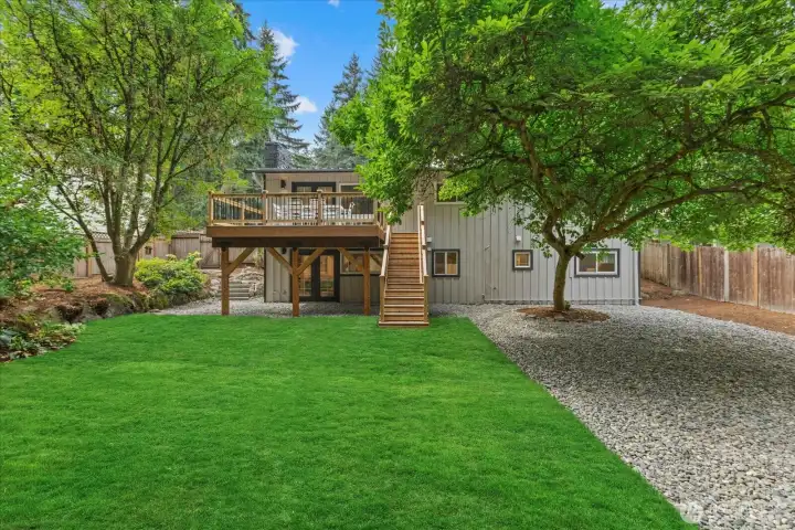 Large, grassy yard with new sod and a beautiful cedar deck connected to the living room for indoor/outdoor living.