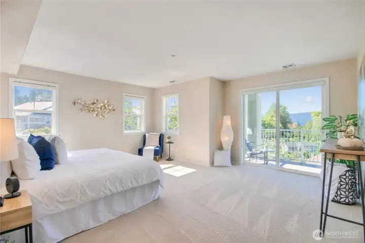 Primary suite with walk in closet, deck with views of pea patch, ensuite, and plenty of windows.