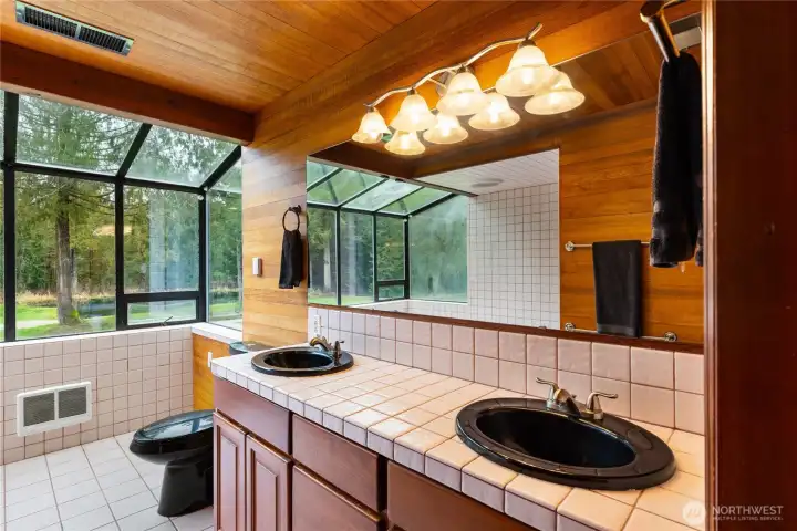 Double sinks in the Primary bath, tile counters & floors