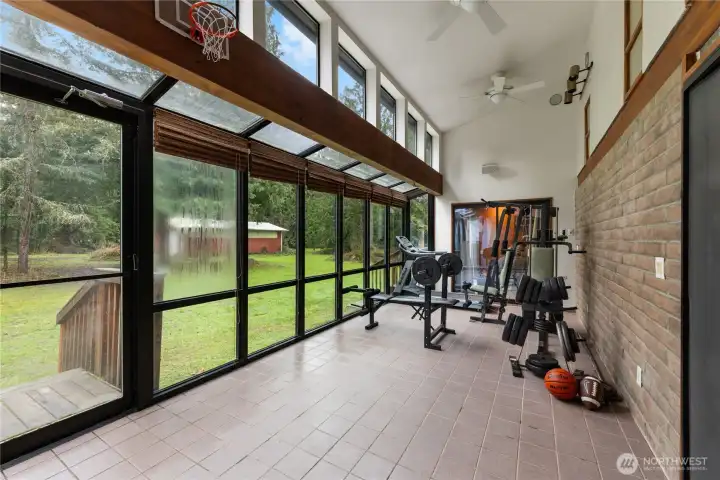 This is the sun room - home to the exercise equipment. Slider in background opens to Primary BR