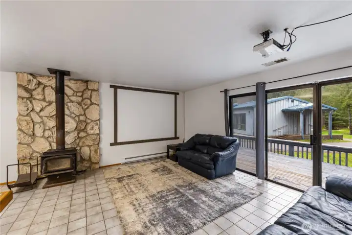 ADU - spacious living room w/ FS wood stove. Tile floor, slider to very spacious deck
