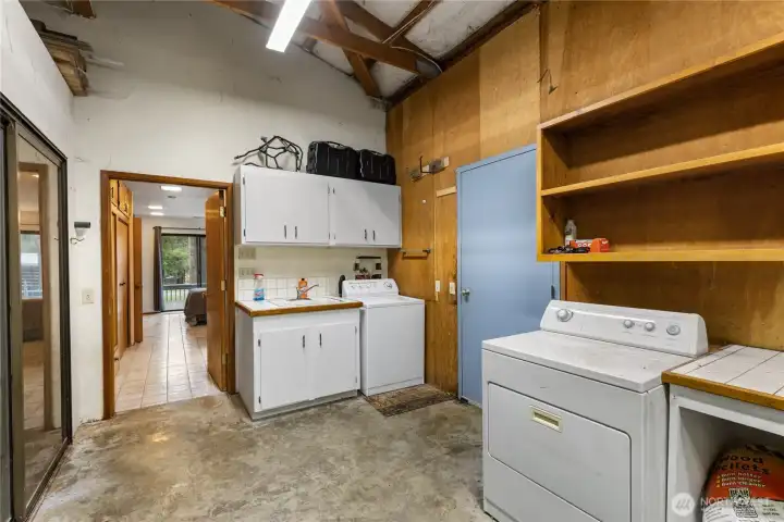 Off the ADU is the adjoining laundry area plus shop. Blue door to the Sports Court & RV hook-ups