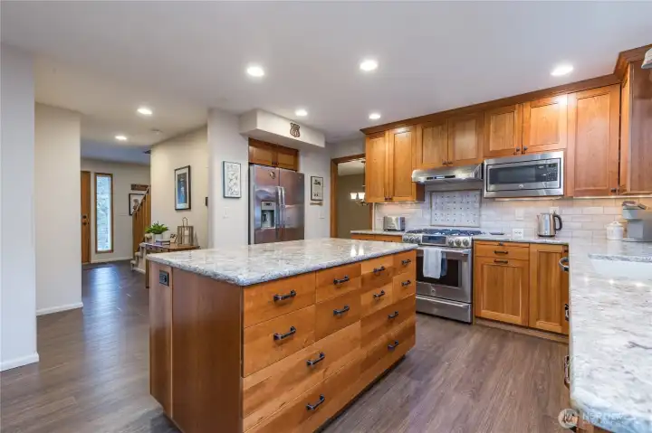 Quartz counters and tiled backsplash add elegance to this highly-functional space