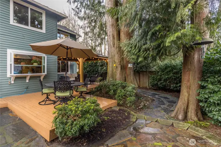 Beautiful wooded corner of the property with flagstone patios and walkways