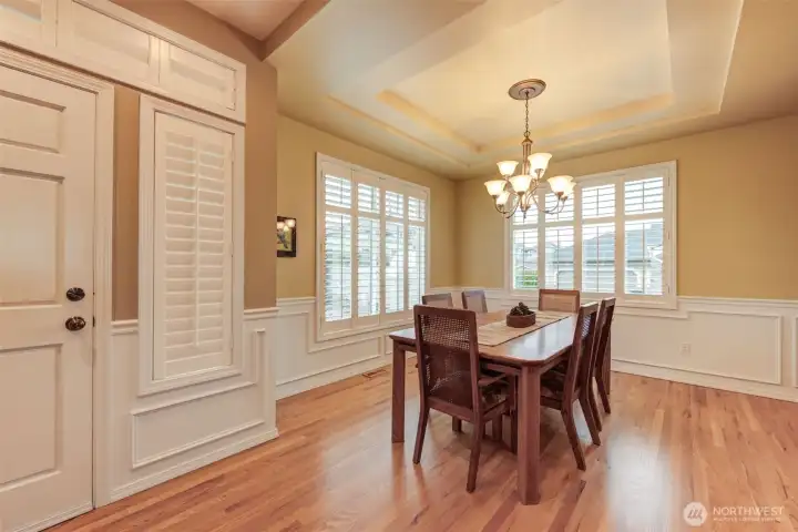 Check out the gorgeous dining room boasting coved ceiling, Plantation Blinds. Great size for family celebrations or entertaining!