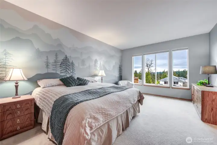 The large primary bedroom enjoys the views and boasts an ensuite 5 piece bathroom with soaking tub AND a walk-in closet.