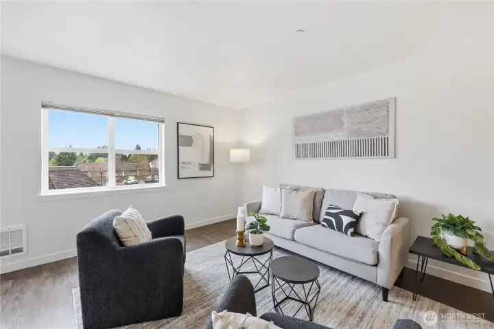 Beautiful laminate flooring in the living room, dining area and kitchen.