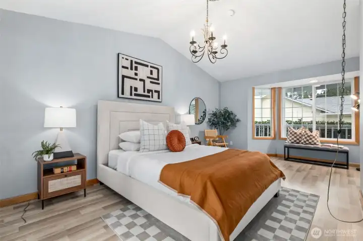 Large Primary Bedroom on the Main floor with cathedral ceilings and large bay windows.