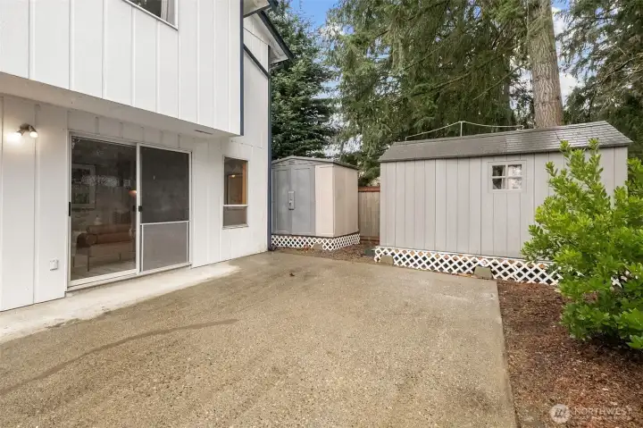 Huge patio . Dog run on the side of the house adjacent to the smaller shed.