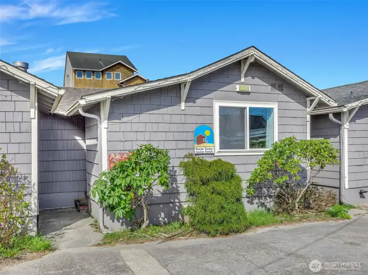 Charming coastal bungalow at Akari Bungalows in Long Beach WA with inviting front entry and low maintenance landscaping.