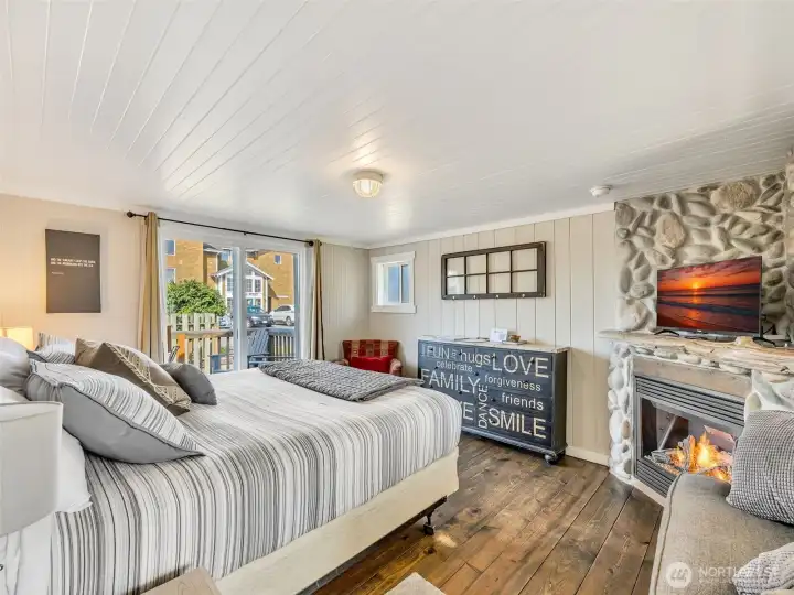 Spacious bedroom with cozy fireplace creating a relaxing coastal retreat in Akari Bungalows