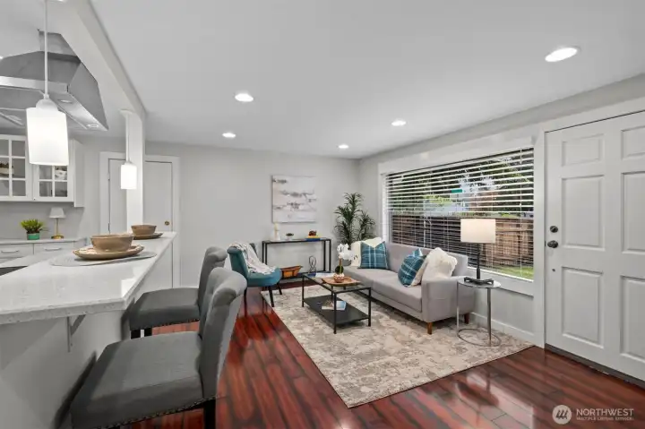 Kitchen with high bar seating area slows seamlessly to the living room.