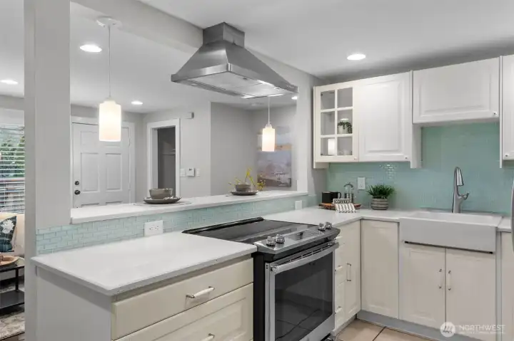 Kitchen features quartz countertops, range with hood for ventilation, farmhouse sink and two lazy Susan's!