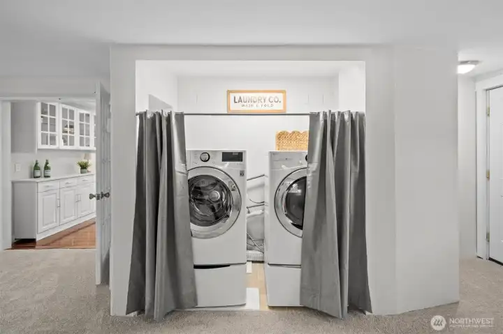 Oversized washer and dryer PLUS additional smaller washer sits below regular washer.