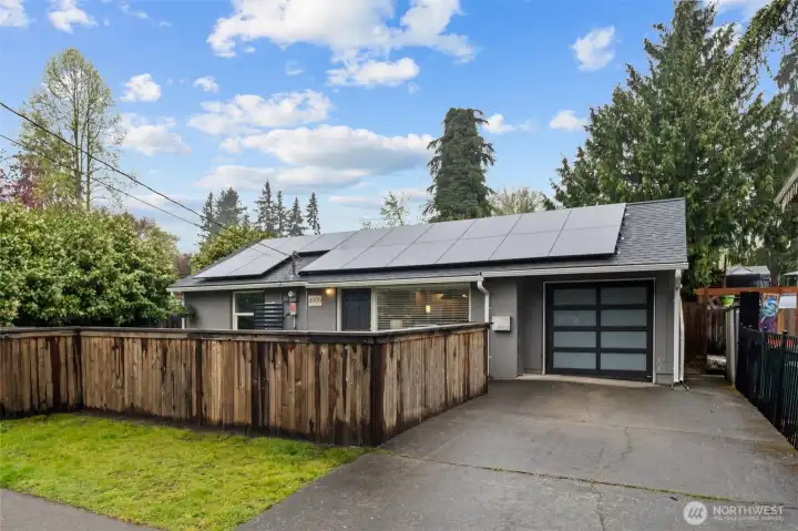 Single car garage with automatic door and access to living room. Solar panels save homeowners significantly on energy bills!