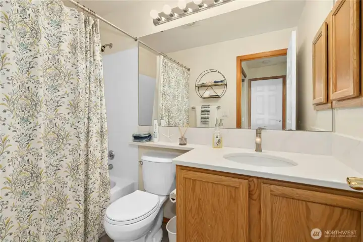 Private bath has new faucets, counter & flooring