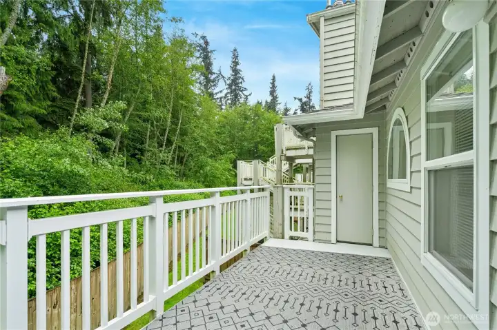 Deck spans the width of the home with views either way and storage closet in back